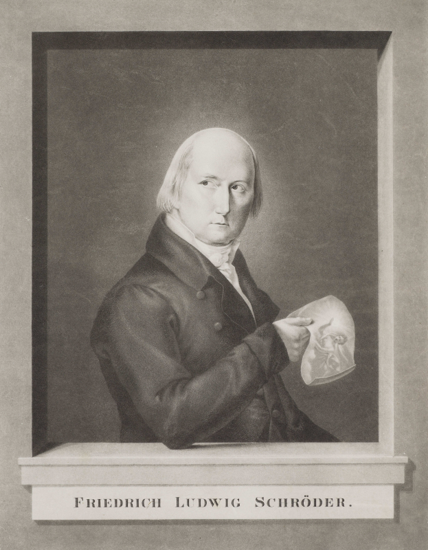 Ein Schwarz-Wei├č-Foto von Friedrich Ludwig Schr├Âder, einem deutschen Komponisten, der einen Anzug tr├Ągt und ein Blatt Papier h├Ąlt und einen ernsten Ausdruck hat.