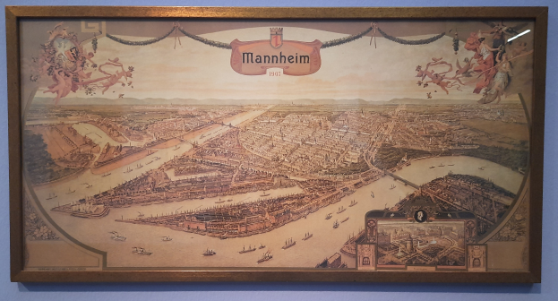 Ein gerahmtes Bild einer lebendigen Stadtlandschaft an einer Museumswand.