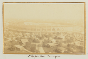 Altes Schwarz-Weiß-Foto eines Stadions in einer städtischen Umgebung mit sichtbaren umliegenden Gebäuden, Bäumen und Strommasten; Text erscheint unten im Bild.